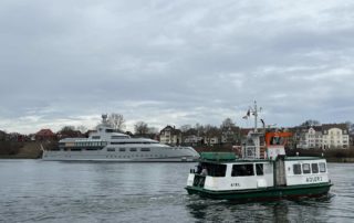 Adler I canal ferry and megayacht 1601 in the Kiel Canal
