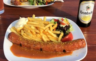 Currywurst with fries and shandy at Surendorf Beach