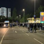 Holstein Kiel fans in front of Holstein Stadium rise party Shell gas station